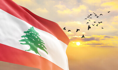 Waving flag of Lebanon against the background of a sunset or sunrise. Lebanon flag for Independence...