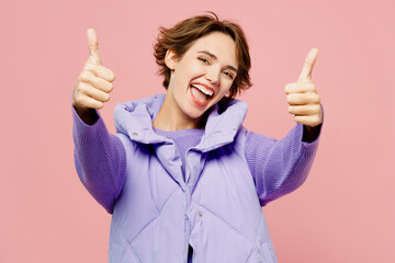 Young smiling satisfied woman she wear purple vest sweatshirt casual clothes showing thumb up like...