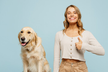 Young smiling happy owner woman with her best friend retriever dog wears casual clothes show thumb...