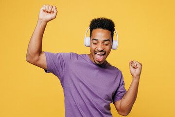 Young cheerful fun happy man of African American ethnicity he wearing purple t-shirt casual clothes...
