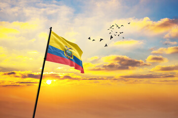 Waving flag of Ecuador against the background of a sunset or sunrise. Ecuador flag for Independence...