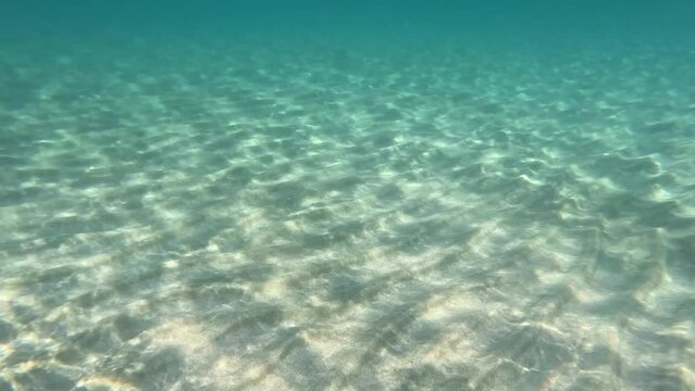Underwater view of the seabed of the beautiful Falassarna beach, Crete, Greece. Quiet day of relaxation and inner peace. Turquoise colored, transparent water.