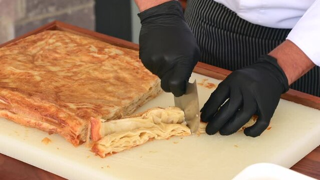Chef cutting Kut or Kurt Borek on white cutting board