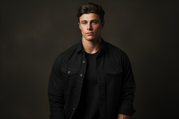 Fototapeta premium Attractive young man in a black shirt looking at the camera A fictional character created by Generated AI. 