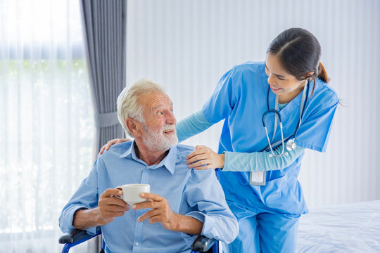 Senior caucasian man get medical service visit from caregiver nurse at home while showing gratitude on appointment for following up on health care and pension welfare insurance concept