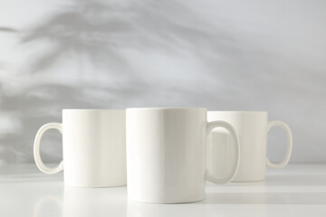 White glass cups on a light background