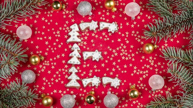 Short animation of Merry Xmas gingerbread cookie text appearing on red cloth fabric decorated with ornaments and wreath