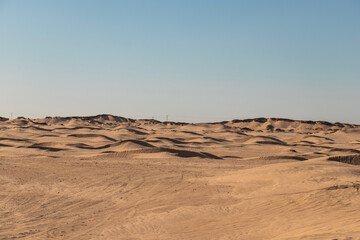 Fototapeta na wymiar Sand dunes in the Sahara desert in Douz, Kebili, Tunisia