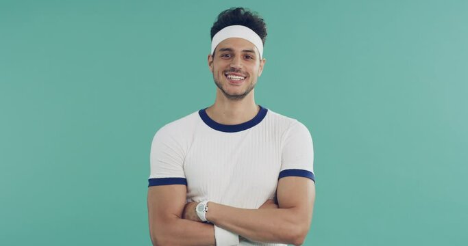 Man, fitness and studio with arms crossed, retro clothes or face with smile for training by green background. Person, model or happy athlete in 80s fashion for workout, wellness or health in portrait