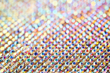 Abstract background made of rhinestones shimmering in the light. - obrazy, fototapety, plakaty
