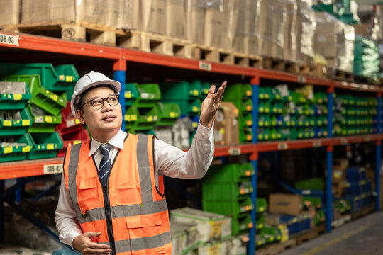 Warehouse manager process paperwork, organize goods by size, shape, category, prepare delivery date