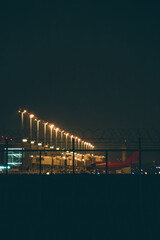 An airplane parking at the terminal with the light shining in the night