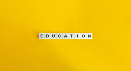 Education Word on Block Letter Tiles on Yellow Background. Minimalist Aesthetics.