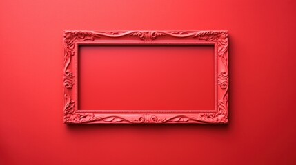 An empty ornate vintage frame with intricate details on a vibrant red background, ideal for artwork or photography display.