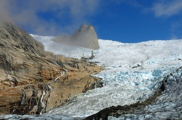  a steep rock spire in the sermeq glacier at the end of the tasermuit fjord on a sunny summer day near nanortalik, in southern greenland