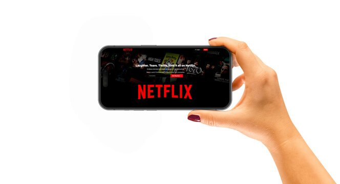 Cracow, Poland - 21 December 2023: iPhone 14 Pro in a woman's hand,  application Netflix.	