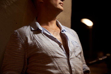 Adult man in a linen shirt with an open collar, summer evening