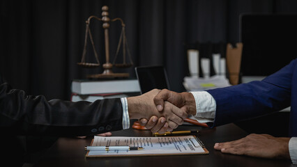 Businessman shaking hands to seal a deal with his partner lawyer or lawyer to discuss agreement,...