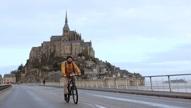 happy man driving his bicycle sightseeing in France