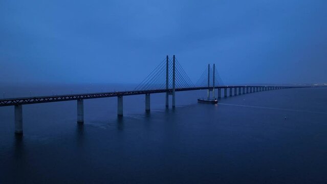 Panoramic Aerial view of Oresund Bridge who is a combined motorway and railway, sea bridge between Denmark and Sweden (Copenhagen and Malmo) and ship - seascape of Baltic Sea, Europe from above