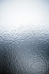 Freezing rain on a window, ice on the windowpane. Frost ice patterns on a window glass. Rime on a...