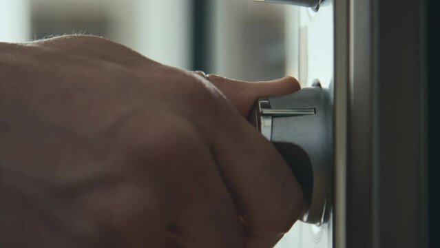 Side stab macro closeup of hand turning on oven using power control in kitchen