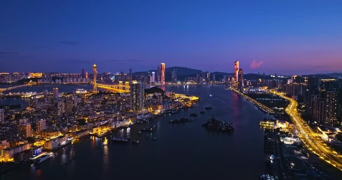 Aerial view of Zhuhai and Macau city skyline with modern buildings scenery at night, China. Famous travel destination. 