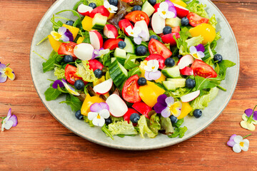 Spring salad with vegetables and flowers.