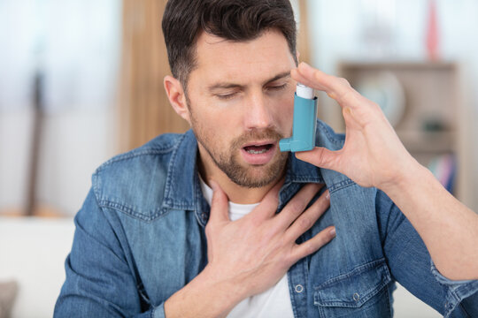 handsome man has asthma takes ventoline