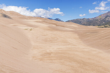 Fototapeta na wymiar High sand dunes and the Rocky Mountains in the Great Sand Dunes National Park
