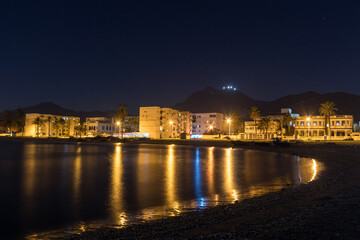 Fototapeta na wymiar A Night View of Houses and Street Lights by the Sea in Tunis.
