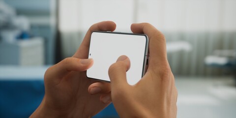 CU Caucasian man doctor or patient using his phone inside hospital room