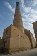View of the minaret of the Islam Khodja madrasa in the old town of Khiva, Uzbekistan.