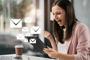Excited woman sitting at table feeling happy black woman overjoyed accepting mail at laptop...