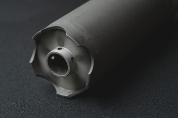 Part from a firearm, professional silencer from a rifle, close-up photo.