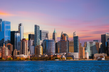 Downtown Manhattan skyline at sunset over Hudson River in New York City
