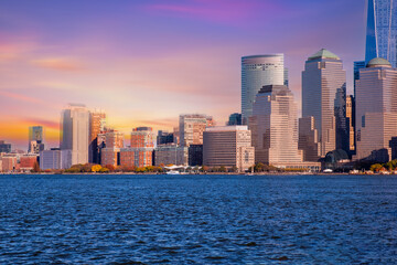 Fototapeta premium Downtown Manhattan skyline at sunset over Hudson River in New York City