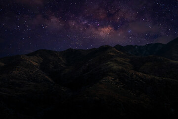 Landscape with Milky Way. Night sky with stars on the mountain,