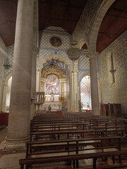 Obraz premium Central nave and columns with arcades and altar in the background at the church of Santa Maria de Marvila, Santarém PORTUGAL