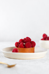 Dessert tartlet with raspberries and cream, fresh dessert for breakfast.