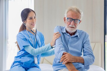 Hospice nurse is using stethoscope on Caucasian man in bed for diagnosing lung cancer of smoking at pension retirement center for home care rehabilitation and post treatment recovery process