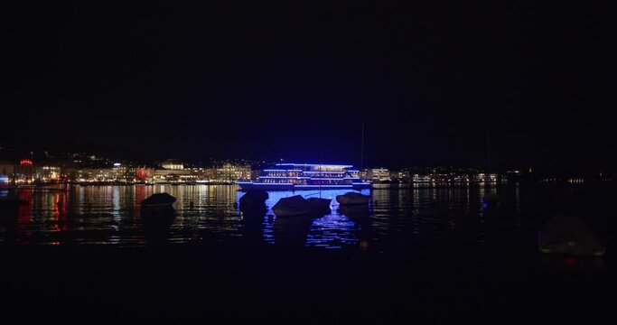 19-12-2023 Zurich, Switzerland. Panta Rhei passenger cruise ship in Burkiplatz ferry terminal at night. Wide angle, illuminated boat, real time, no people