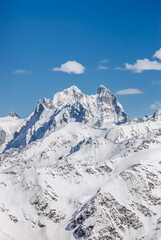 Snowy mountains. Beautiful landscape with snowy rocks. View from the top of Mount Elbrus - 696344573