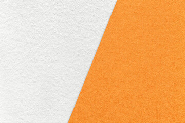 Texture of craft white and orange paper background, half two colors, macro. Vintage kraft ginger...