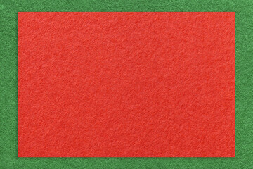 Texture of craft red color paper background with green border, macro. Structure of vintage kraft...