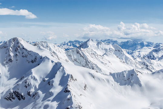 Snow-covered winter mountains of the Caucasus on a sunny day. Panoramic view from the ski slope of Elbrus, Kabardino-Balkaria, Russia