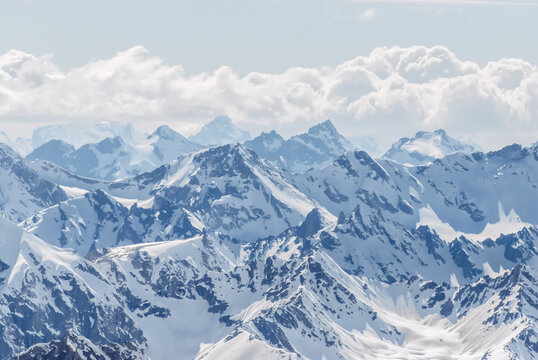 Snow-covered winter mountains of the Caucasus on a sunny day. Panoramic view from the ski slope of Elbrus, Kabardino-Balkaria, Russia
