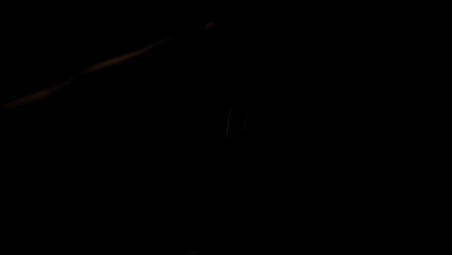 Fingers hitting strings on electric guitar, close up neck fretboard. Guitarist slides his hand across fingerboard. Rock sound. Musical solo performance in dark studio. Flashing blinking light, strobe