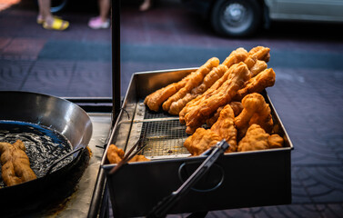 Deep-fried Patongko flour is sold on a cart in Yaowarat, Thailand.