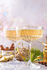 Two champagne glass on Christmas decorated background